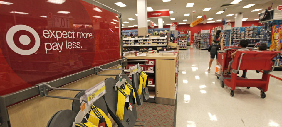 A customer pulls her cart down an aisle at a Target store on Thursday, July 5, 2012, in Chicago. The discount retailer said Thursday that a key revenue measure rose 2.1 percent in June as shoppers spent more on food and health and beauty items. But the growth in revenue at stores open at least one year was slightly lower than the 2.4 percent rise that analysts surveyed by Thomson Reuters expected. (AP Photo/M. Spencer Green)