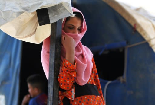 A displaced Iraqi girl stands in "Camp Seven" near al-Khalidiyeh in Iraq's western Anbar province on April 24, 2018