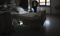 A man carries his plastic bag of belongings as he prepares to leave the COVID-19 ward at the St. Michiel Hospital in Brussels, Tuesday, Nov. 24, 2020. The Belgian military has been called into several hospitals and care homes to alleviate the stress on healthcare personnel. (AP Photo/Virginia Mayo)