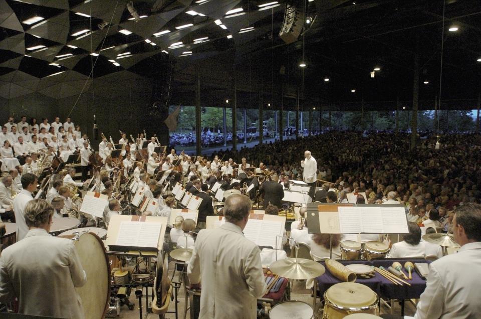 ARCHIVO – En esta fotografía del 9 de julio de 2004 Kurt Masur dirige a la Orquesta Sinfónica de Boston en la noche inaugural de la temporada en el foro Tanglewood en Lenox, Massachussets. La Orquesta Sinfónica de Boston anunció el 19 de marzo de 2021 que su temporada al aire libre en Tanglewood regresará con conciertos en vivo y en persona del 9 de julio al 16 de agosto. El festival se canceló en 2020 por la pandemia de COVID-19. (Foto AP/Paul Franz, archivo)