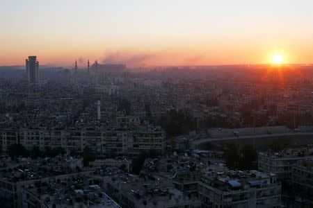 The sun rises while smoke is pictured near Aleppo's historic citadel, as seen from a government-controlled area of Aleppo, Syria December 6, 2016. REUTERS/Omar Sanadiki