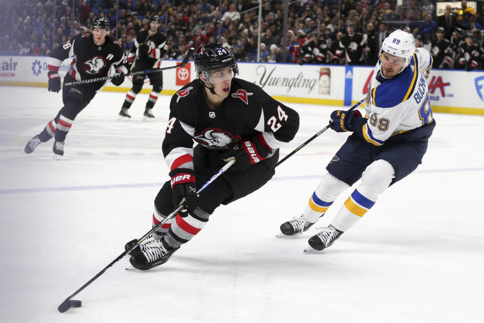 Buffalo Sabres center Dylan Cozens (24) skates while pursued by St. Louis Blues left wing Pavel Buchnevich (89) during the first period of an NHL hockey game Wednesday, Nov. 23, 2022, in Buffalo, N.Y. (AP Photo/Joshua Bessex)