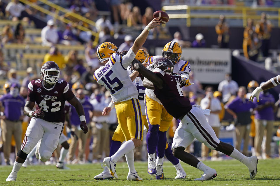 LSU quarterback Myles Brennan (15) passes under pressure from Mississippi State safety Jordan Davis (6) and defensive end Marquiss Spencer (42) in the first half an NCAA college football game in Baton Rouge, La., Saturday, Sept. 26, 2020. (AP Photo/Gerald Herbert)