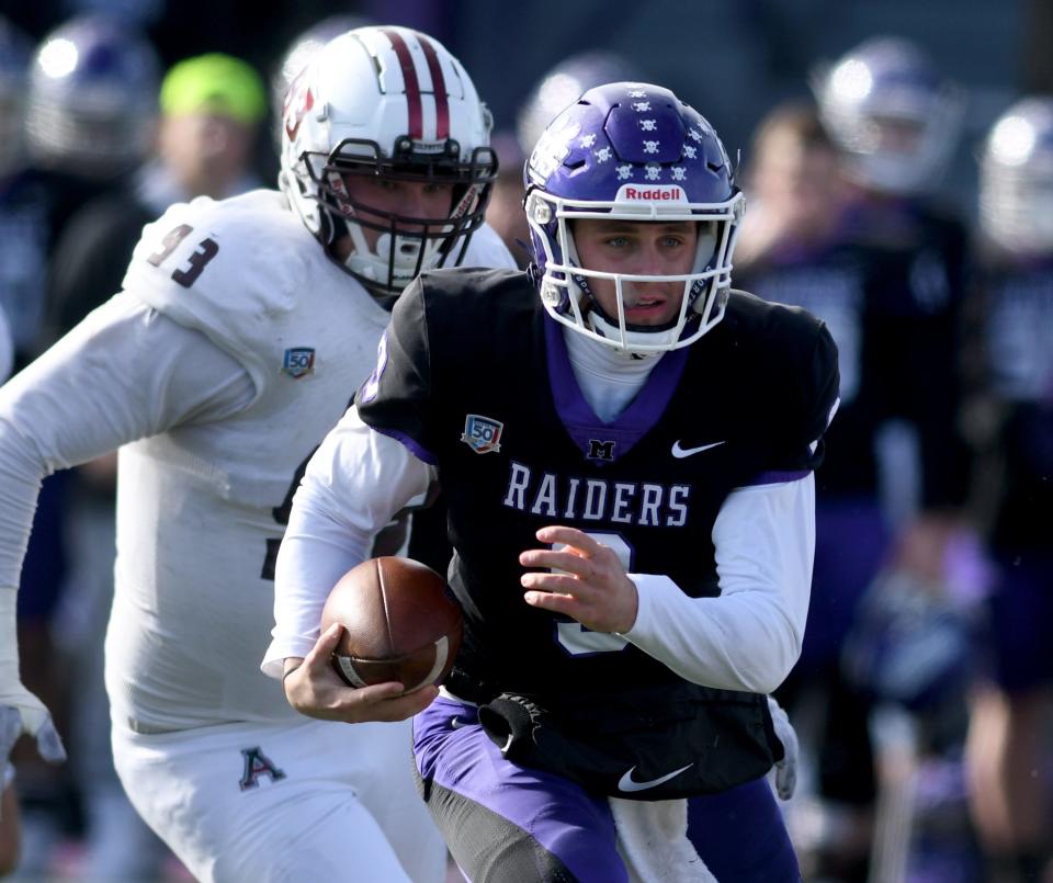 Mount Union quarterback Braxton Plunk runs for a second-quarter first down vs. Alma in an NCAA Division III second-round playoff game. Saturday, Nov. 25, 2023.