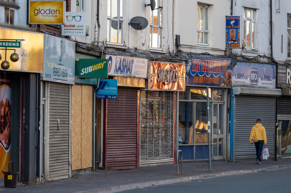 CARDIFF, UNITED KINGDOM - APRIL 21: Closed shops on Cowbridge Road East during the coronavirus lockdown period on April 21, 2020 in Cardiff, United Kingdom.The British government has extended the lockdown restrictions first introduced on March 23 that are meant to slow the spread of COVID-19. (Photo by Matthew Horwood/Getty Images)