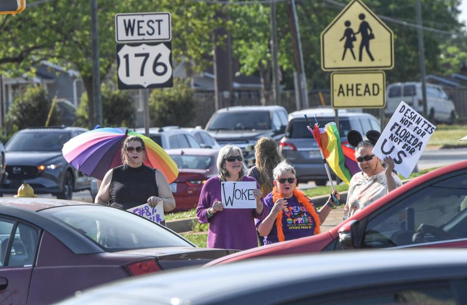 Protesters stand on the corner of Highway 176 at First Baptist North Spartanburg church before Florida Gov. Ron DeSantis arrives in Spartanburg, S.C. Wednesday, April 19, 2023. 