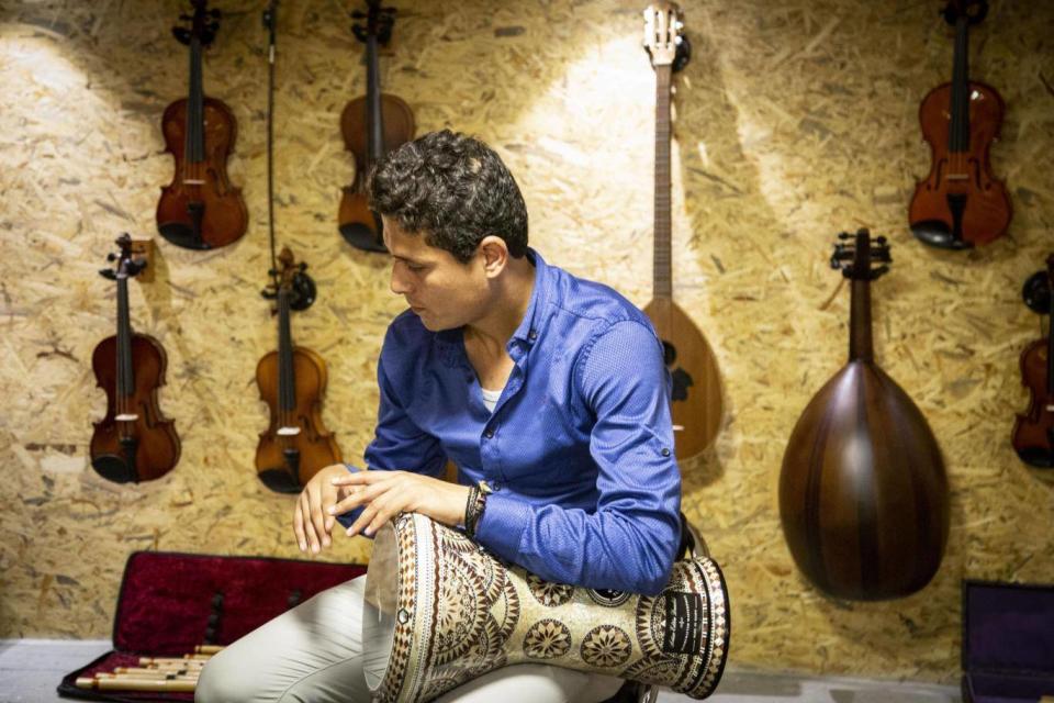 Mohamed plays a Tabla in Gaza’s first music shop (Photo: Bel Trew)