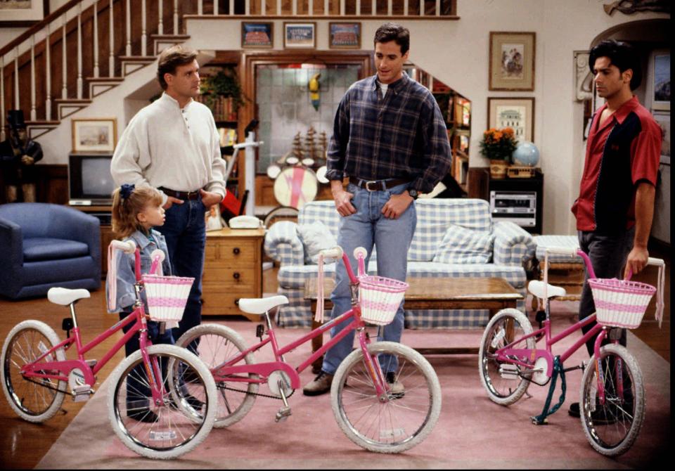 Mary-Kate Olsen, who portrayed Michelle Tanner on "Full House," along with her sister Ashley Olsen, appears in a 1993 episode of the family sit-com with Dave Coulier (Joey Gladstone) left, Bob Saget (Danny Tanner), and John Stamos (Jesse Katsopolis).