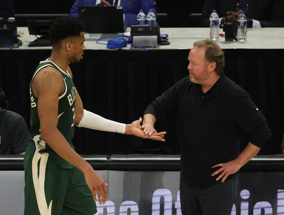 MILWAUKEE, WISCONSIN - JULY 11: Giannis Antetokounmpo #34 of the Milwaukee Bucks gets a high five from head coach Mike Budenholzer of the Milwaukee Bucks during the second half in Game Three of the NBA Finals against the Phoenix Suns at Fiserv Forum on July 11, 2021 in Milwaukee, Wisconsin. NOTE TO USER: User expressly acknowledges and agrees that, by downloading and or using this photograph, User is consenting to the terms and conditions of the Getty Images License Agreement. (Photo by Jonathan Daniel/Getty Images)