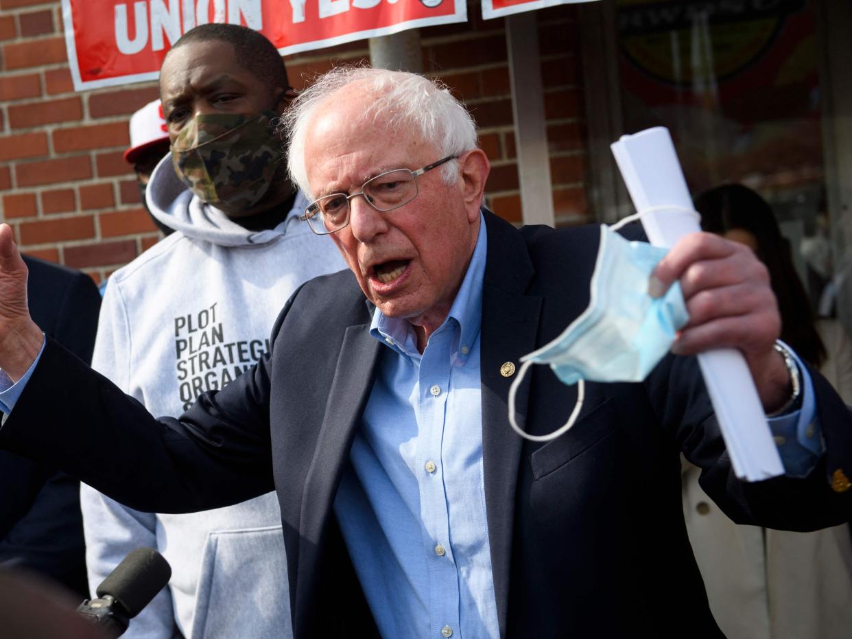 Senator Bernie Sanders and Rapper Michael “Killer Mike” Render (L) speak in support of the unionization of Amazon.com, Inc. fulfillment centre workers outside the Retail, Wholesale and Department Store Union (RWDSU) in Birmingham, Alabama on 26 March 2021 ((AFP via Getty Images))