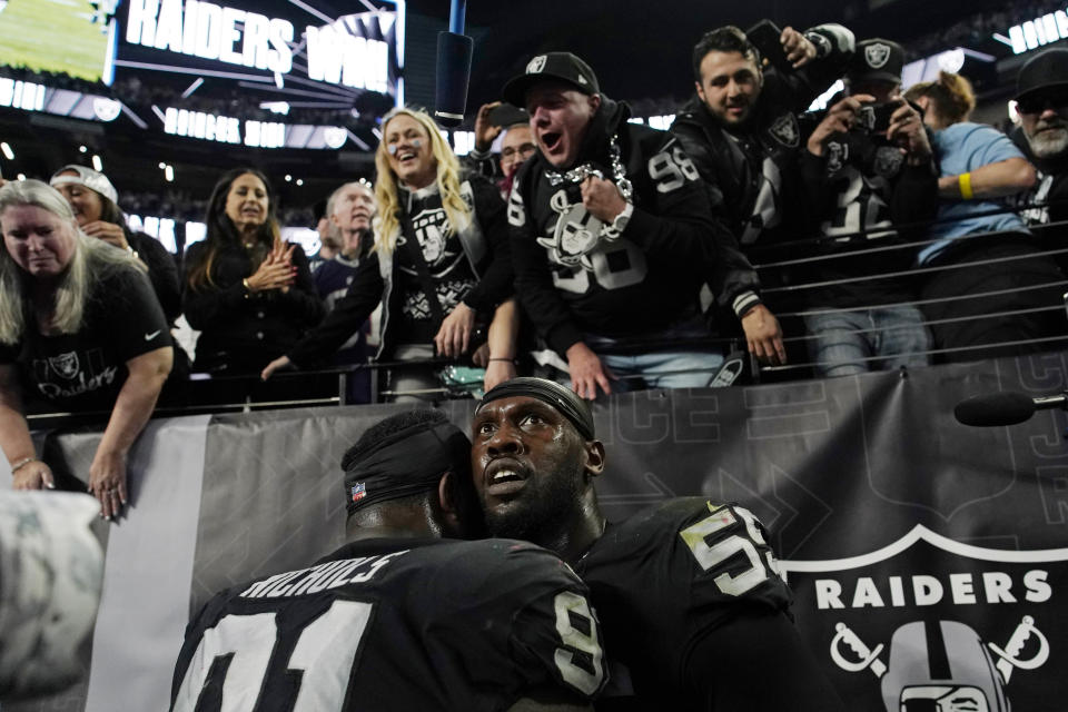 Las Vegas Raiders defensive end Chandler Jones, right, reacts after scoring on an interception during the second half of an NFL football game, Sunday, Dec. 18, 2022, in Las Vegas. (AP Photo/John Locher)