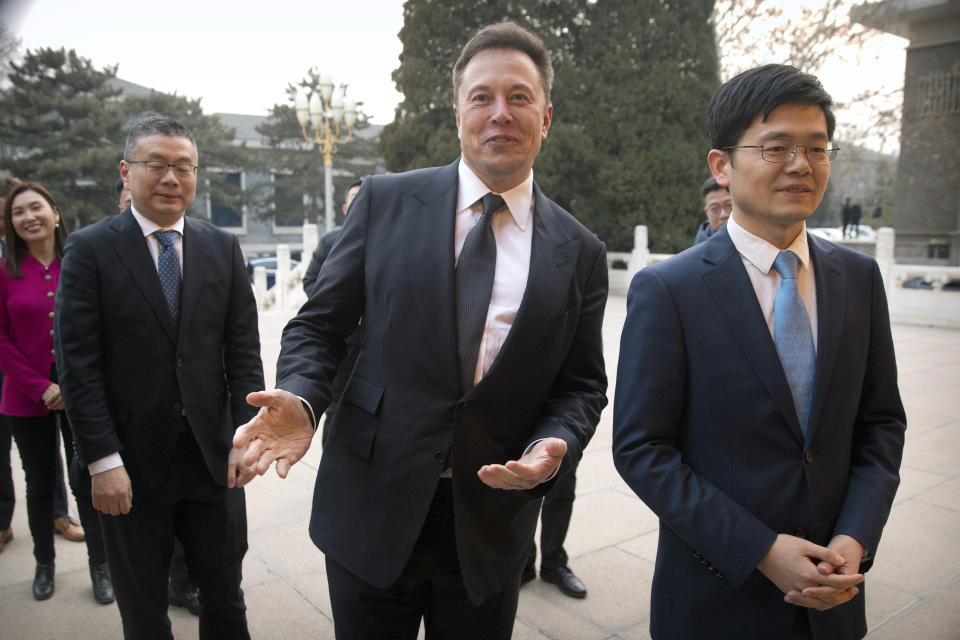FILE - Tesla CEO Elon Musk, center, gestures as he waits for a meeting with Chinese Premier Li Keqiang at the Zhongnanhai leadership compound in Beijing, Wednesday, Jan. 9, 2019. Many people are puzzled on what a Elon Musk takeover of Twitter would mean for the company and even whether he’ll go through with the deal. If the 50-year-old Musk’s gambit has made anything clear it’s that he thrives on contradiction. (AP Photo/Mark Schiefelbein, Pool, File)