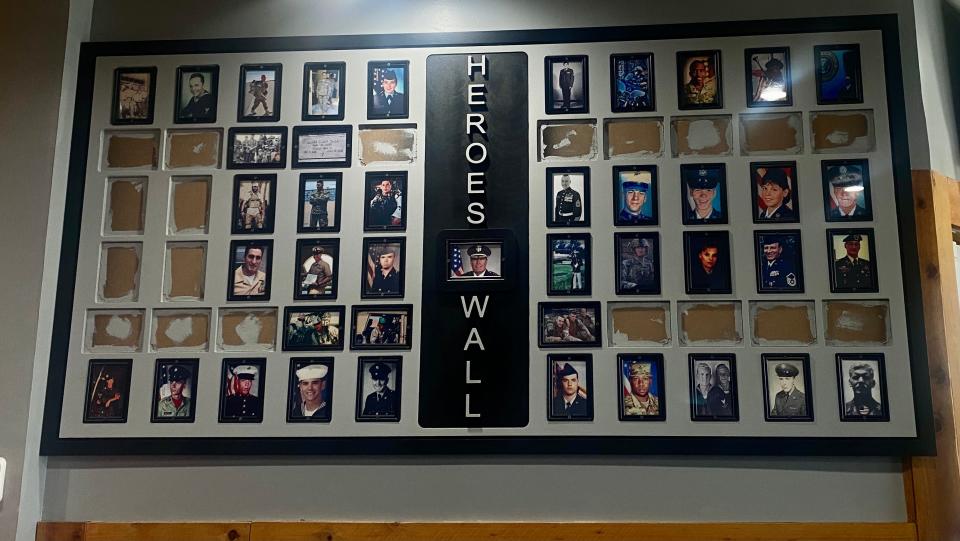 A Heroes Wall commemorating military and police officers with a montage of their portraits in uniform is displayed inside Single Tree.