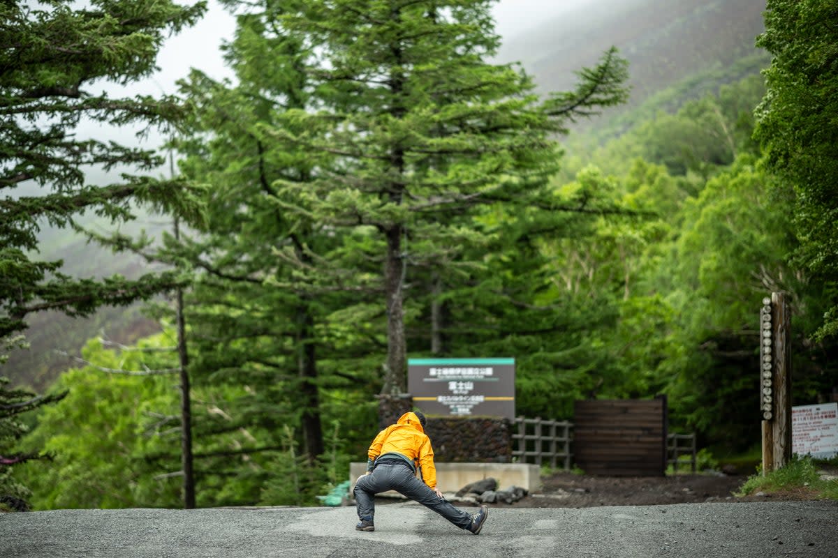 A staffer works out in front the newly installed trail gate at Fuji Subaru Line 5th station, which leads to the Yoshida trail to climb Mount Fuji (AFP via Getty)