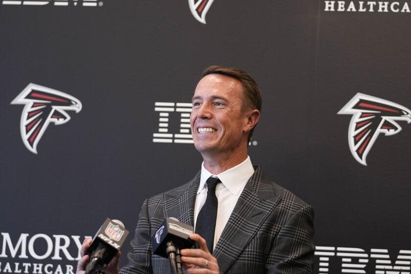 Former Atlanta Falcons' quarterback Matt Ryan smiles at the podium as he announces his retirement.