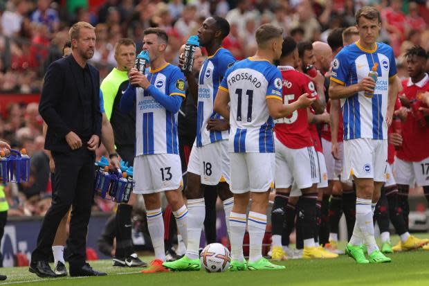 Graham Potter with his Brighton team during a break in play at Old Trafford. Picture Richard Parkes