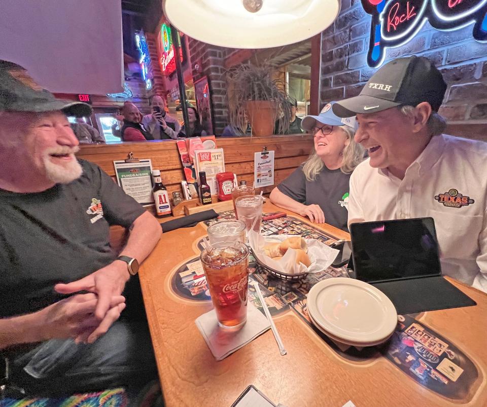 Mike and Judy McNamara of Franklin, Virginia, share a laugh with Texas Roadhouse CEO Jerry Morgan, far right. The couple were dining at their 400th Texas Roadhouse, in Ontario, when they were surprised by the boss of the steakhouse franchise.