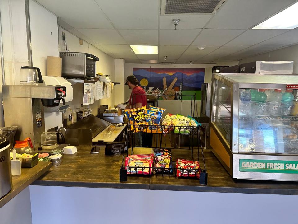 Co-owner Coy Leach prepares a chopped cheese sandwich at Knox Bodegas.