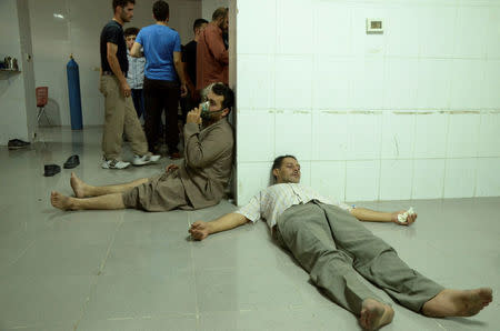 FILE PHOTO: People, affected by what activists say was a gas attack, are treated at a medical centre in the Damascus suburb of Saqba, Syria August 21, 2013. REUTERS/Bassam Khabieh/File Photo