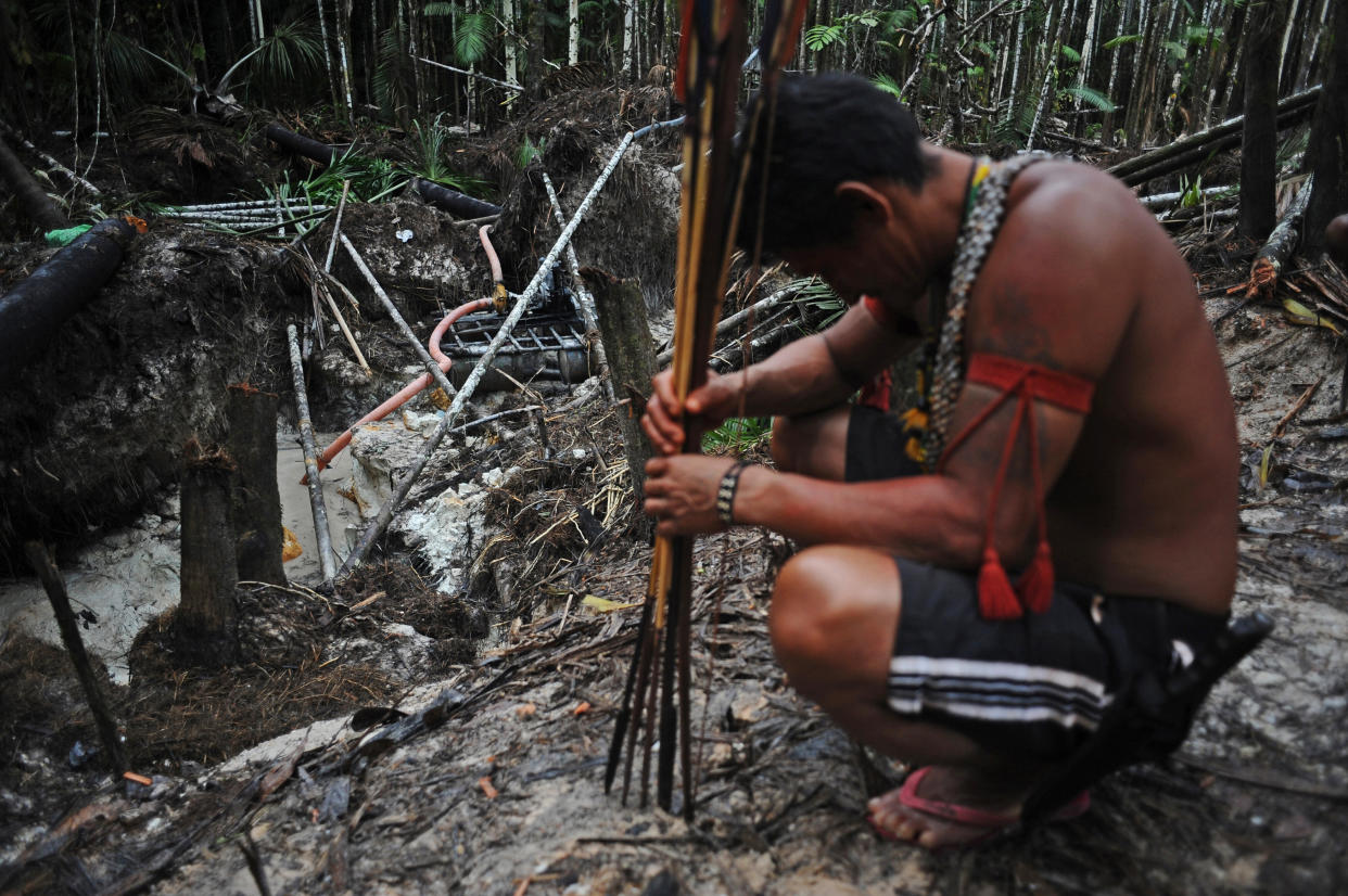 Munduruku warriors arrive at an area of jungle cleared by wildcat gold miners as they search for illegal gold mines and miners in their territory. (Photo: Lunae Parracho/Reuters)