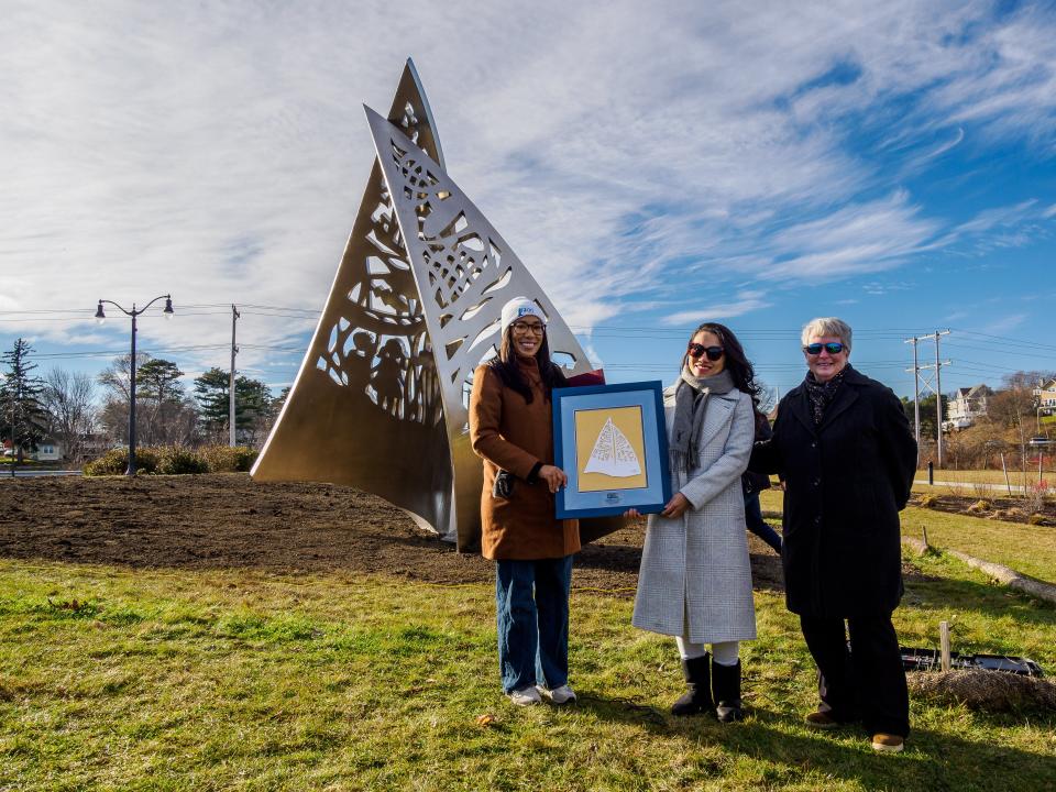 The sculpture “Endeavor” is presented to the city by Portsmouth NH 400 Tuesday, Dec. 12, 2023. From left are Assistant Mayor Joanna Kelley, with an original papercut of the design, artist Sijia Chen and Valerie Rochon, managing director of Portsmouth NH 400.
