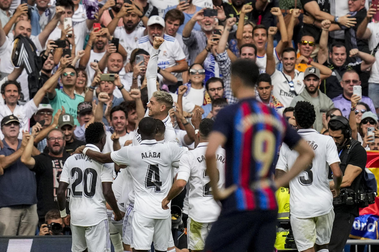 Real Madrid's Federico Valverde is congratulated by teammates after scoring during La Liga soccer match between Real Madrid and FC Barcelona in Madrid, Spain, Sunday, Oct. 16, 2022. (AP Photo/Bernat Armangue)
