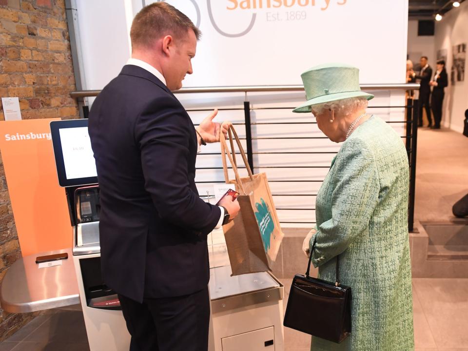 Queen Elizabeth at a self checkout kiosk