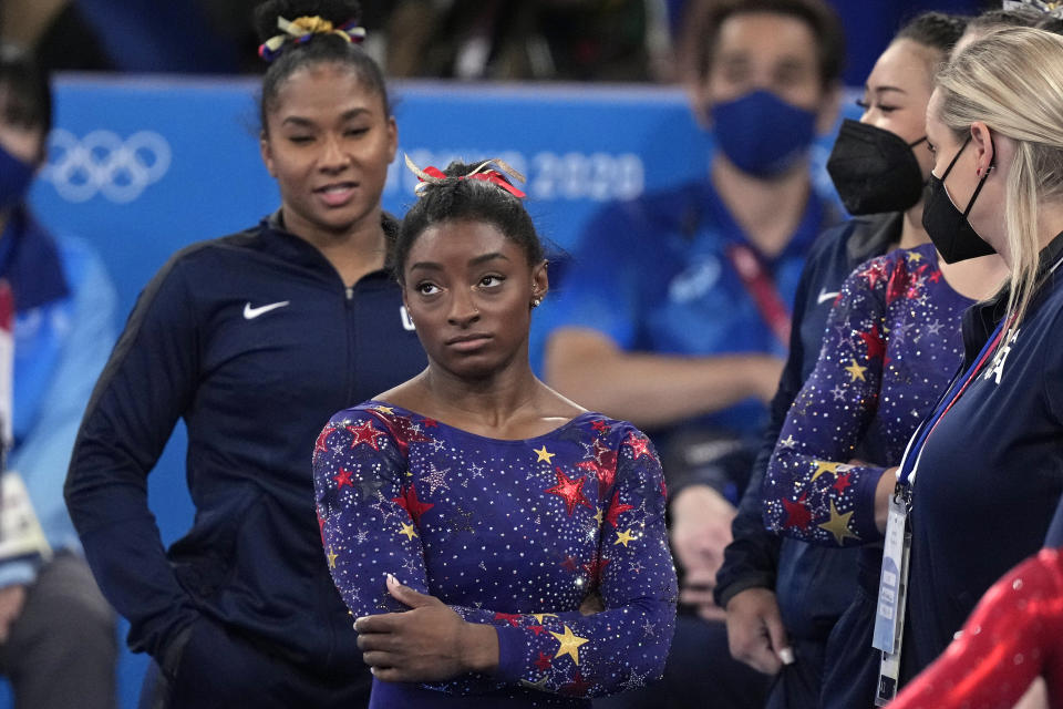Simone Biles, of the United States, waits for her score after performing on the balance beam during the women's artistic gymnastic qualifications at the 2020 Summer Olympics, Sunday, July 25, 2021, in Tokyo. (AP Photo/Gregory Bull)