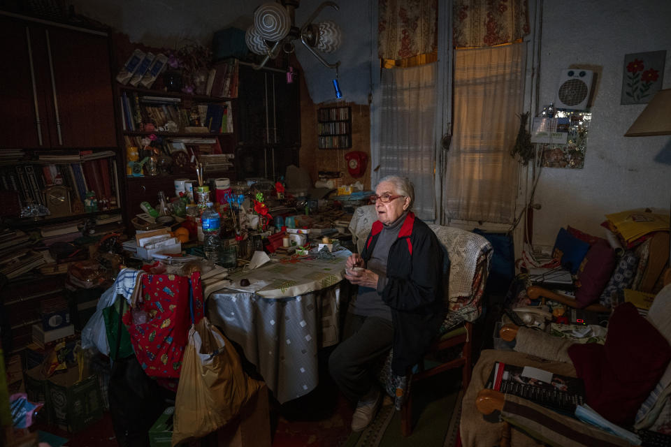 Francisca Cano Vila, 80, watches television while eating a yogurt for Christmas Eve dinner at her home in Barcelona, Spain, Thursday, Dec. 24, 2020. Many of Barcelona's elderly poor who live alone feel more isolated than ever on a Christmas Eve without family or friends due to pandemic restrictions in Spain. For these seniors, the night before Christmas will consist of a yogurt or a cold sandwich without more company than, perhaps, the television. (AP Photo/Emilio Morenatti)