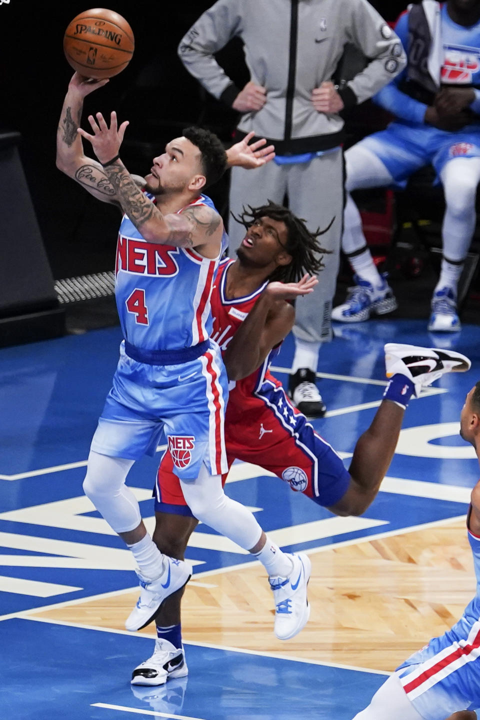 Brooklyn Nets' Chris Chiozza, left, drives past Philadelphia 76ers' Tyrese Maxey during the first half of an NBA basketball game Thursday, Jan. 7, 2021, in New York. (AP Photo/Frank Franklin II)