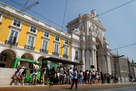 FILE PHOTO: Tourists wait for a tram at Comercio square in downtown Lisbon, Portugal August 17, 2018. REUTERS/Rafael Marchante/File Photo