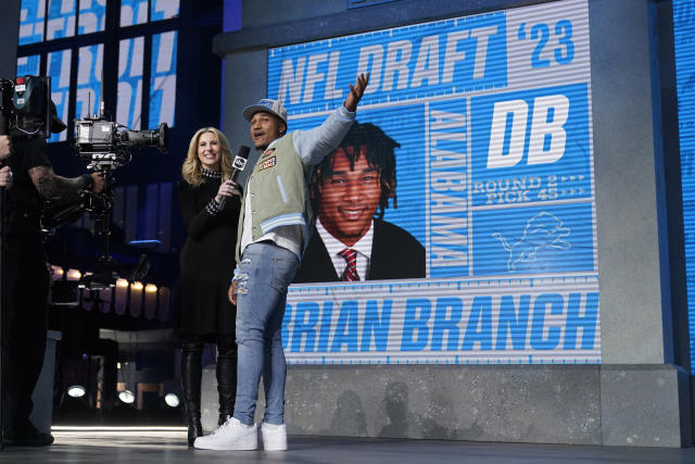 Alabama defensive back Brian Branch, right, reacts after being chosen by the Detroit Lions during the second round of the NFL football draft, Friday, April 28, 2023, in Kansas City, Mo. (AP Photo/Jeff Roberson)