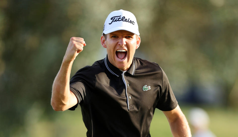 Yannik Paul fist pumps after holing his putt