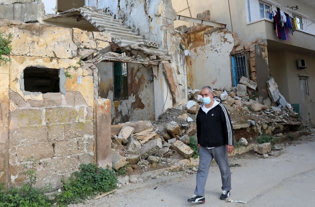 Local resident outside buildings damaged by the explosion. (Photo: ANWAR AMRO via AFP via Getty Images)