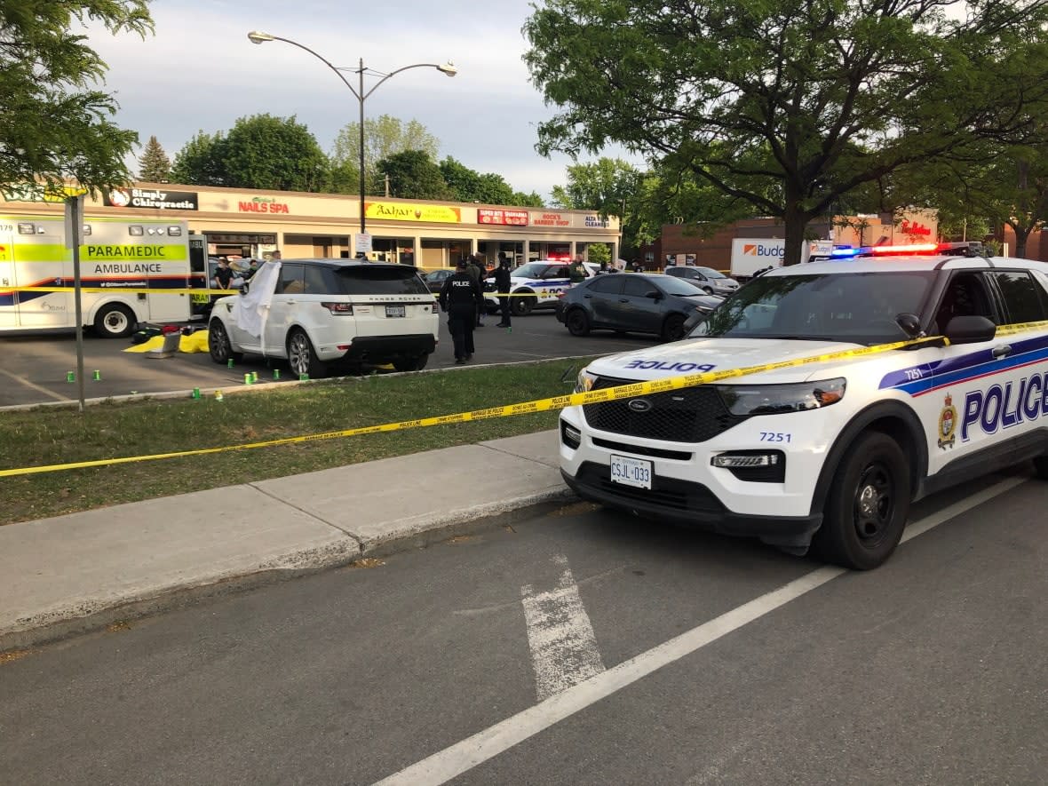 Police are seen here at the scene of the drive-by shooting on Alta Vista Drive in May 2021 that left two brothers dead and a third brother shot in the leg. (Mathieu Thériault/CBC - image credit)