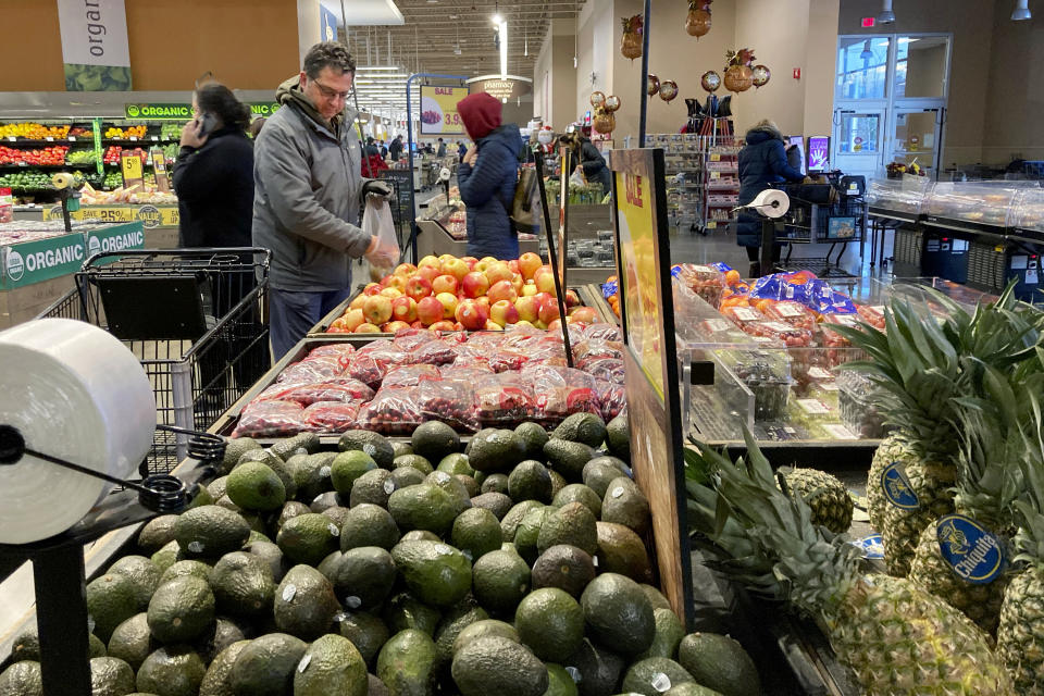 FILE - Shoppers pick out items at a grocery store in Glenview, Ill., on Nov. 19, 2022. American consumers and nearly every industry will be affected if freight trains grind to a halt in December. It would take about a week for customers to notice shortages of things like cereal, peanut butter and beer at the grocery store, said Tom Madrecki, vice president of supply chain for the Consumer Brands Association. About 30% of all packaged food in the U.S. is moved by rail, he said. (AP Photo/Nam Y. Huh, File)