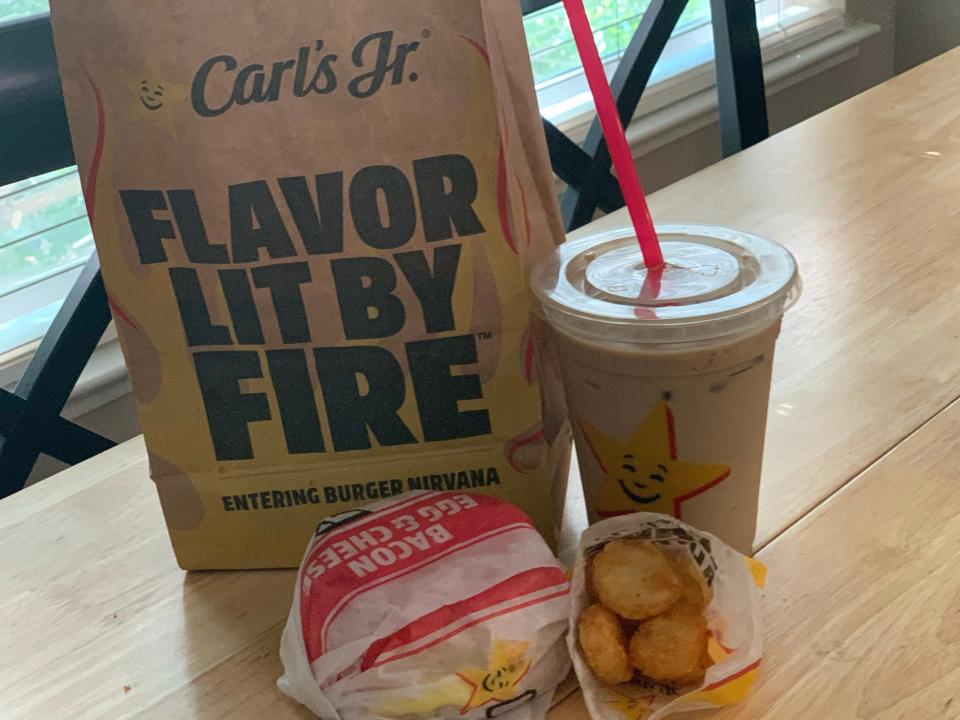 Carl's Jr breakfast spread on a wooden table