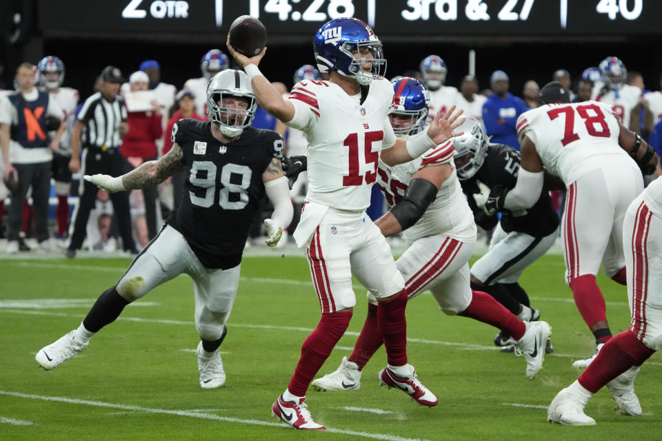 New York Giants quarterback Tommy DeVito (15) throws under pressure during the first half of an NFL football game against the Las Vegas Raiders, Sunday, Nov. 5, 2023, in Las Vegas. (AP Photo/Rick Scuteri)