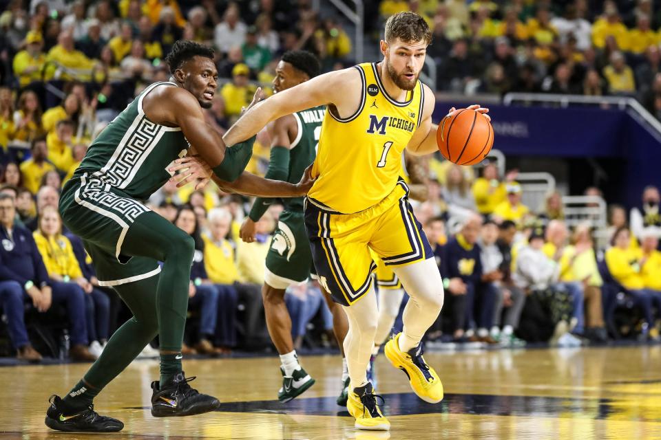 Then with Michigan, Hunter Dickinson looks to make a play during a Feb. 18, 2023 game against Michigan State in Ann Arbor.