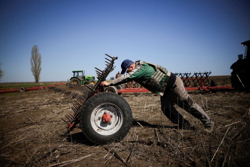 Ukrainian farmer wears body armour to plough frontline fields