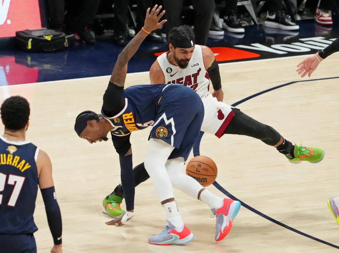 Jun 4, 2023; Denver, CO, USA; Denver Nuggets guard Kentavious Caldwell-Pope (5) battles for the ball against Miami Heat guard Gabe Vincent (2) during the third quarter in game two of the 2023 NBA Finals at Ball Arena. Mandatory Credit: Kyle Terada-USA TODAY Sports