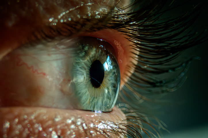 Close-up shot of a human eye with detailed focus on the iris and eyelashes