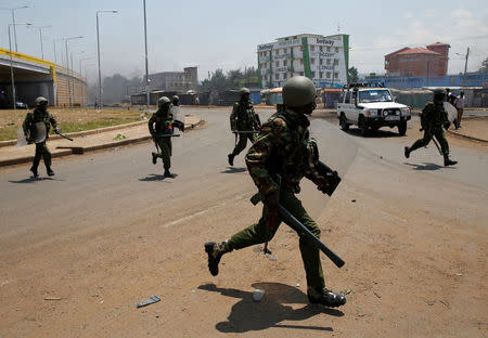 Policemen chase protesters in Kisumu, Kenya August 11, 2017. REUTERS/Baz Ratner