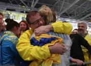 <p>Olga Kharlan of Ukraine embraces friends and family after winning the bronze medal following her bout against Manon Brunet of France during the Women’s Individual Sabre Bronze Medal Bout on Day 3 of the Rio 2016 Olympic Games at Carioca Arena 3 on August 8, 2016 in Rio de Janeiro, Brazil. (Photo by Patrick Smith/Getty Images) </p>