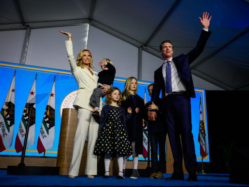 Gavin Newsom and Jennifer Siebel Newsom stand with their four children.