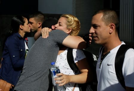 Cubans congratulate fellow citizens minutes before heading to their asylum interview to the United States at the premises of the state migrant assistance office in Ciudad Juarez