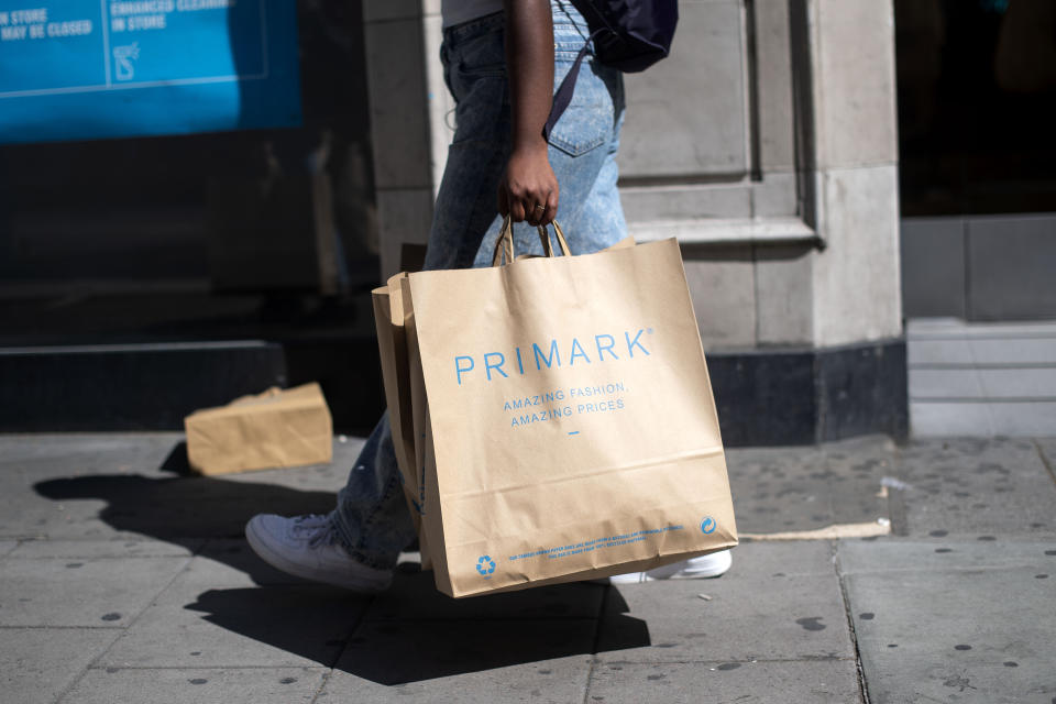 A customer carries bags of shopping as they leave Primark in Oxford Street. Photo: Victoria Jones/PA