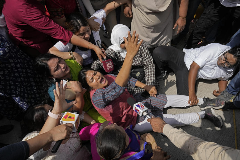 Members of Aam Admi Party, or Common Man's Party, shout slogans during a protest against the arrest of their party leader Arvind Kejriwal in New Delhi, India, Tuesday, March 26, 2024. Indian police have detained dozens of opposition protesters and prevented them from marching to Prime Minister Narendra Modi’s residence to demand the release of their leader and top elected official of New Delhi who was arrested last week in a liquor bribery case. (AP Photo/Manish Swarup)