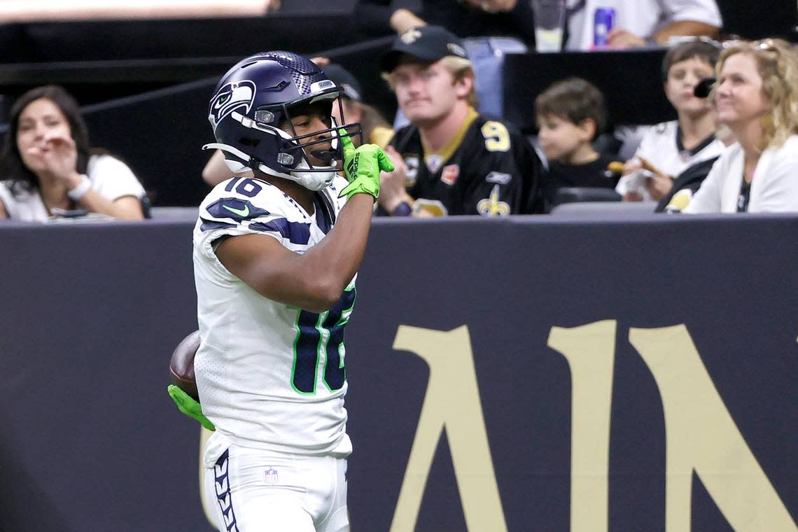 Seattle Seahawks wide receiver Tyler Lockett silences the crowd after catching a touchdown pass from quarterback Geno Smith during an NFL football game against the New Orleans Saints in New Orleans, Sunday, Oct. 9, 2022. (AP Photo/Derick Hingle)