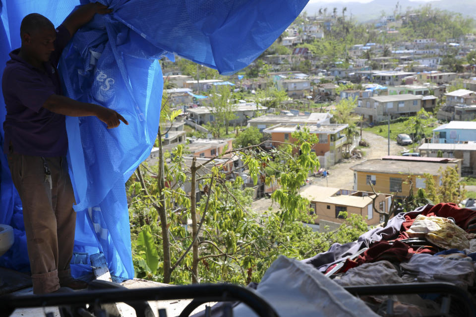 Danny Guerrero Herrera in mid-October shows HuffPost what's behind the blue tarp a charitable organization gave him after Hurricane Maria's winds ripped away most of his home's roof and several walls in Can&oacute;vanas, Puerto Rico. (Photo: Carolina Moreno/HuffPost)